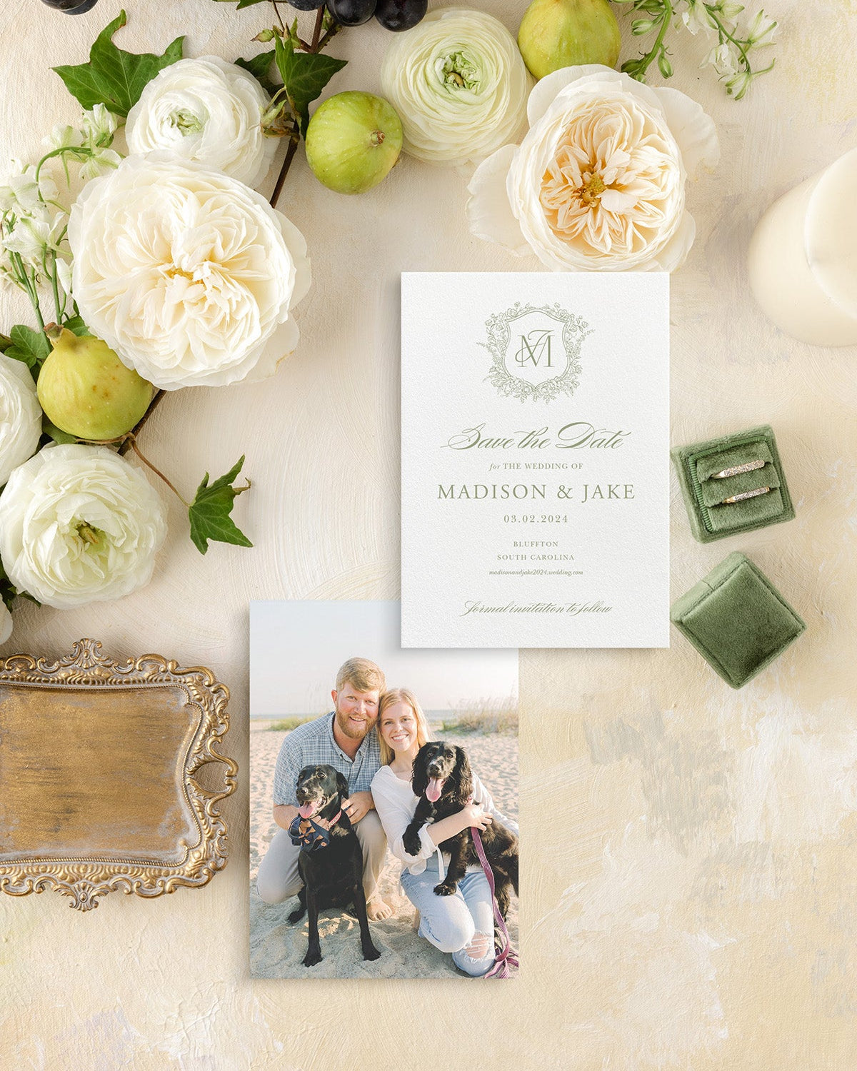 Wedding Save the Date with photo of couple and dogs, surrounded by fruits and flowers on a decorative surface.
