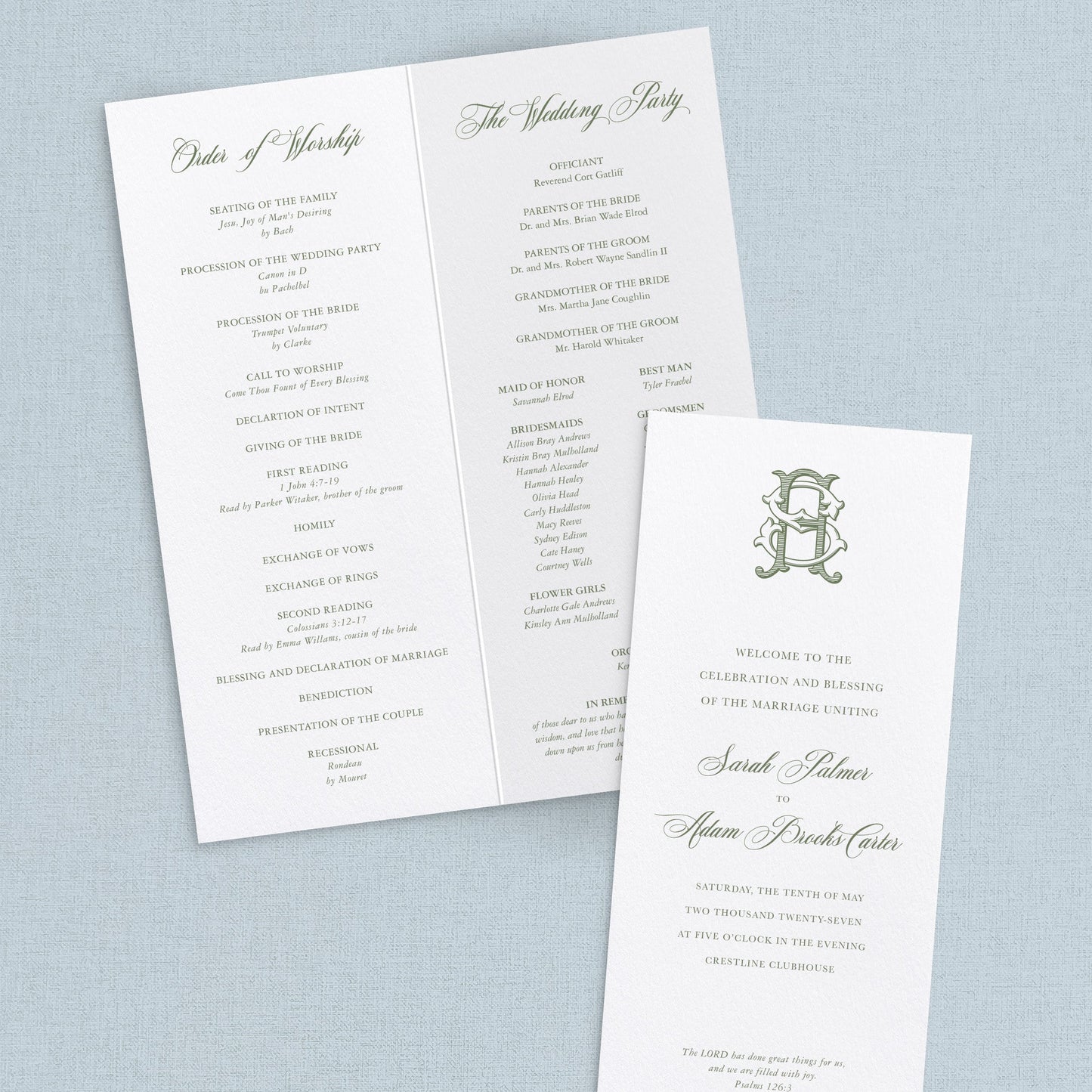 Set of wedding programs with a monogram on a light blue background