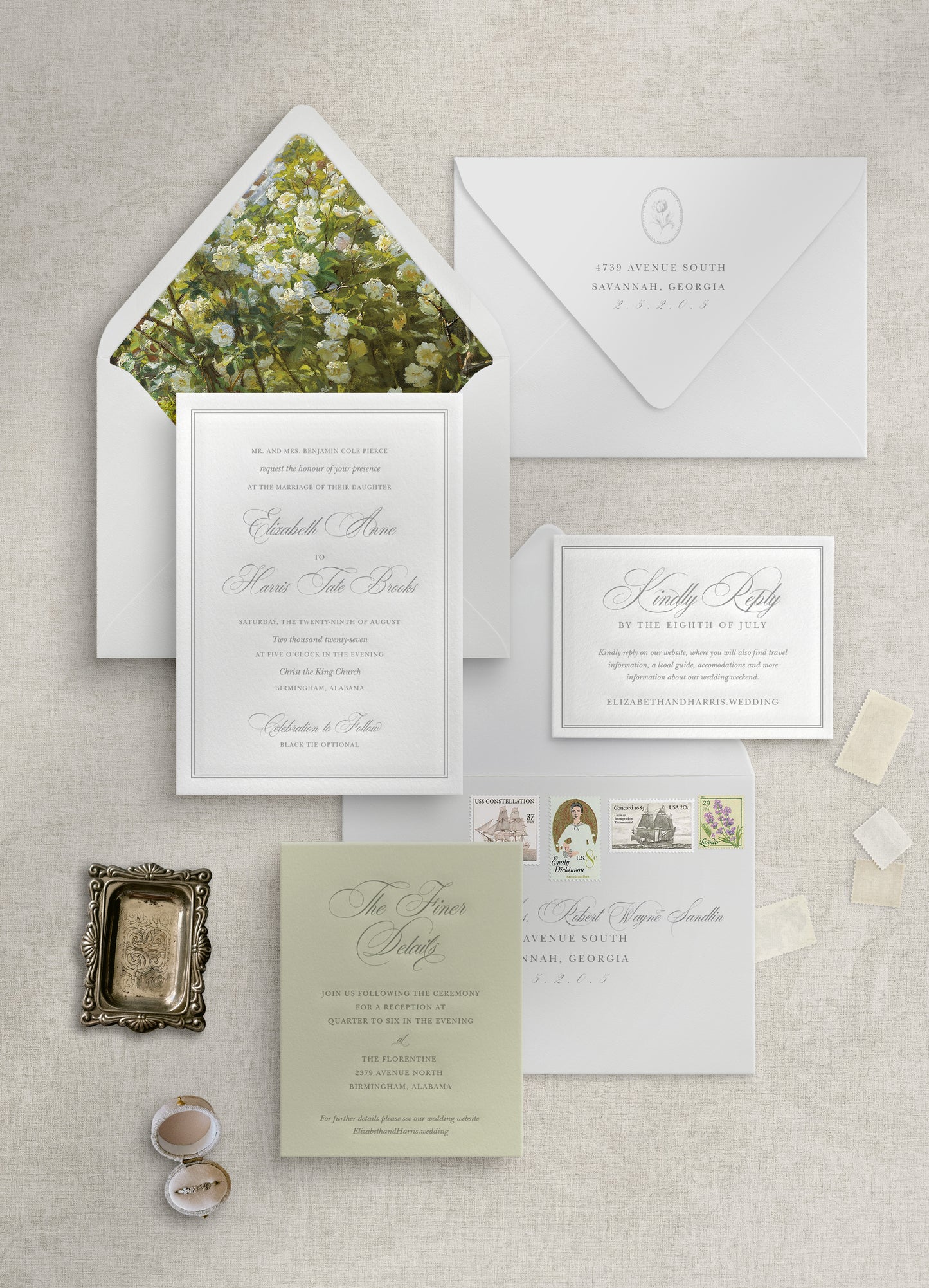 Collection of wedding invitations and stationery on a textured surface