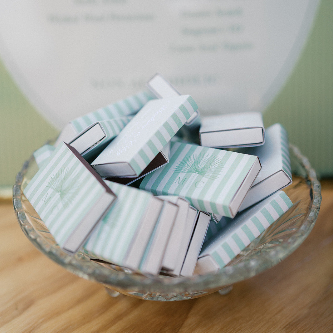Small striped boxes in a glass bowl on a wooden surface with a blurred background